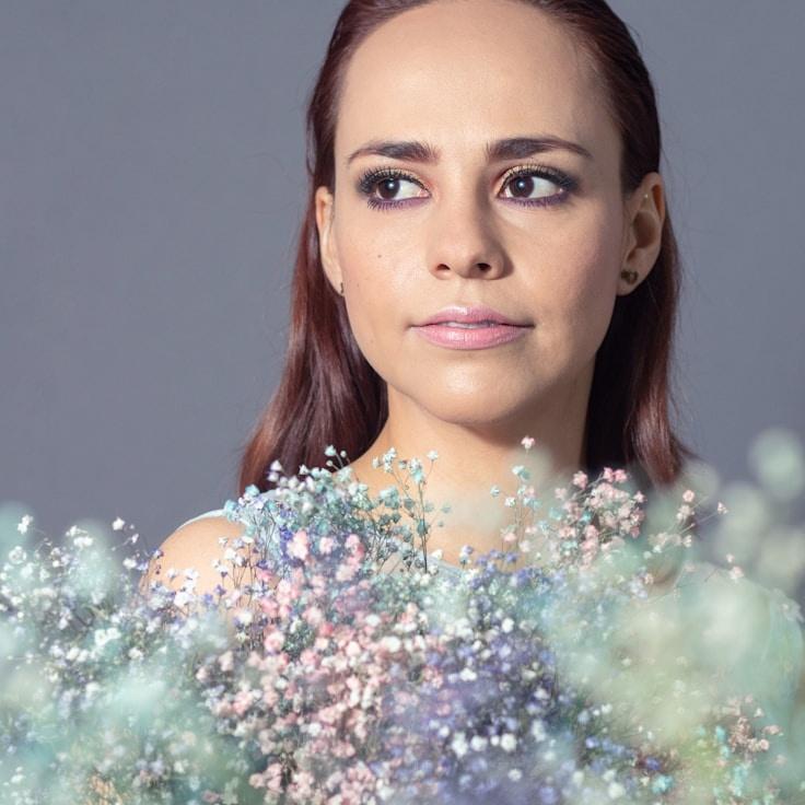 Kaveri Mehta, Lead Design Curator at RiverCraftStudio, reviewing corporate floral arrangements